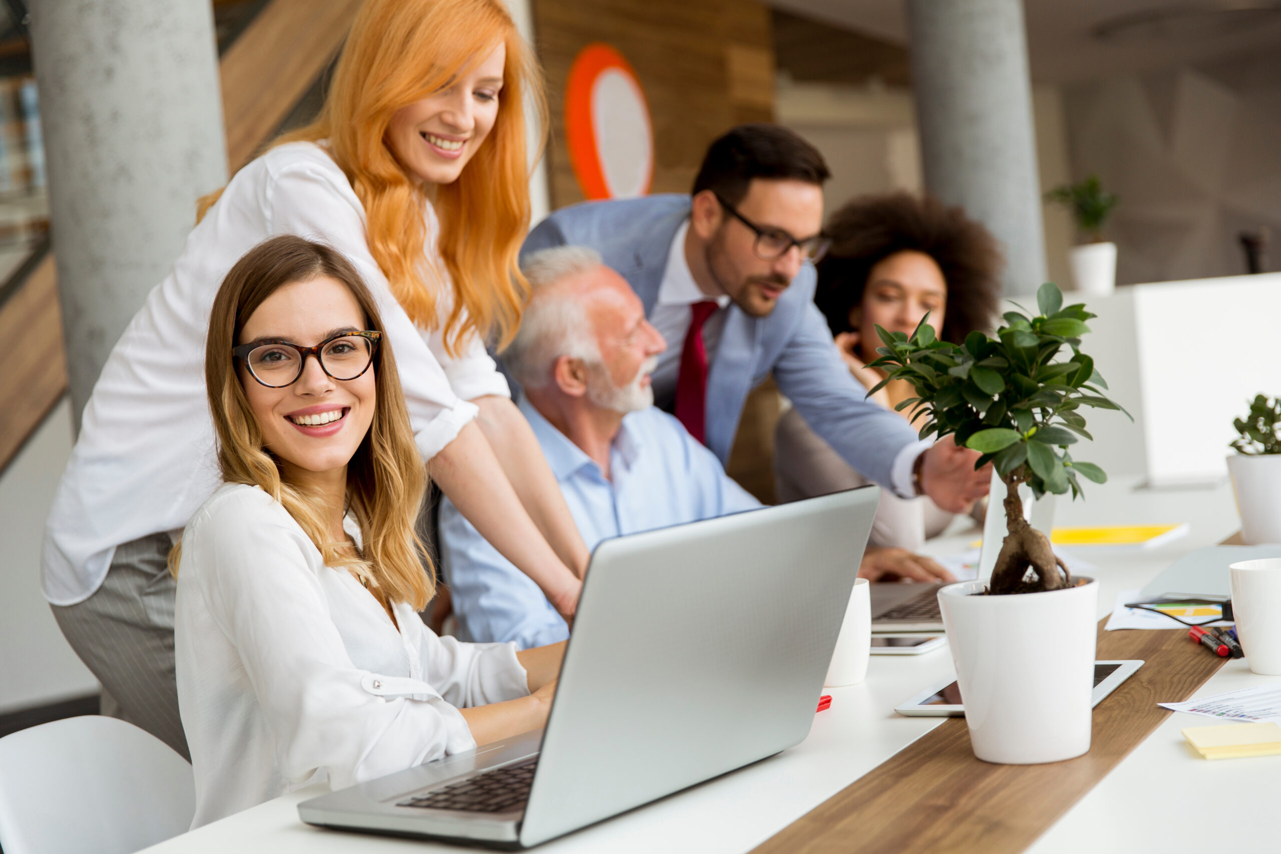 Group of businessmen and businesswomen working together in the modern office